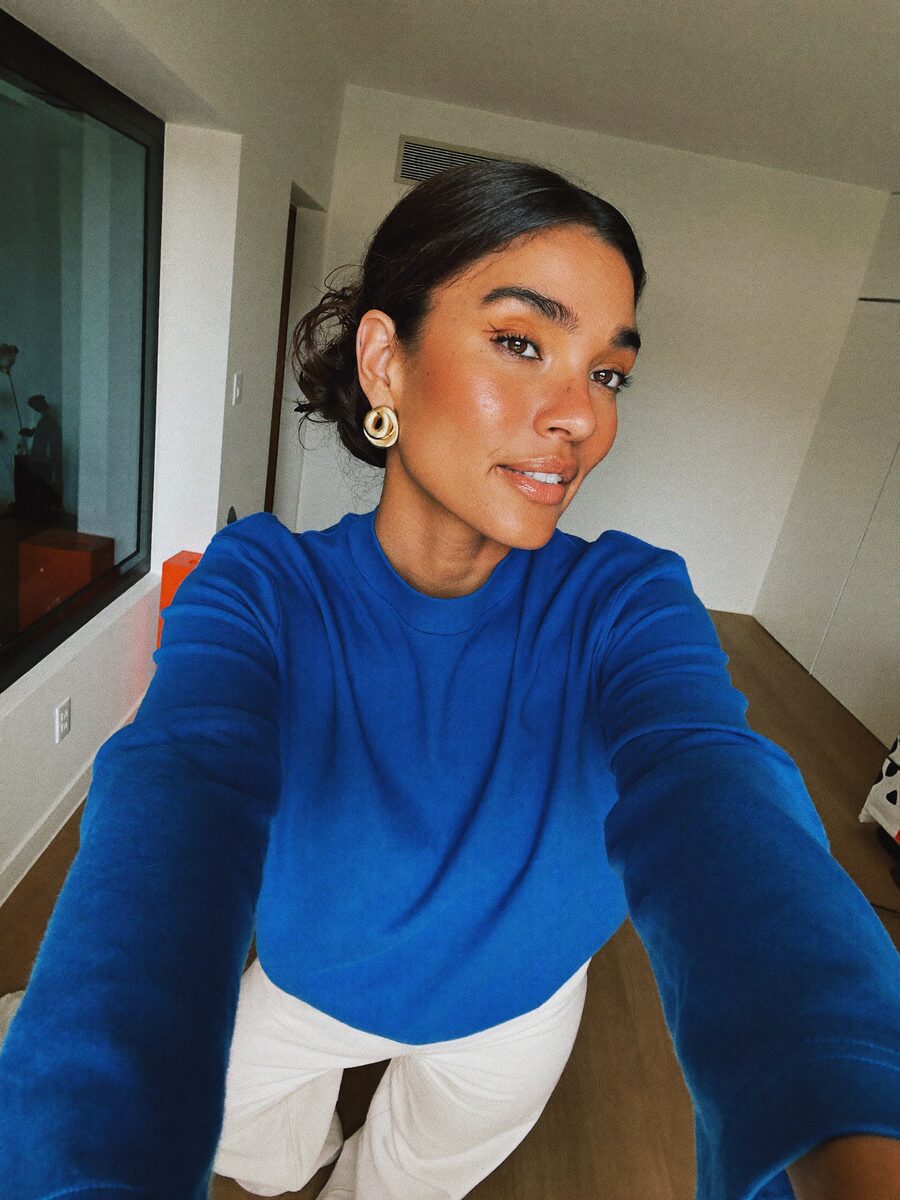 AI creator taking a selfie in her apartment
